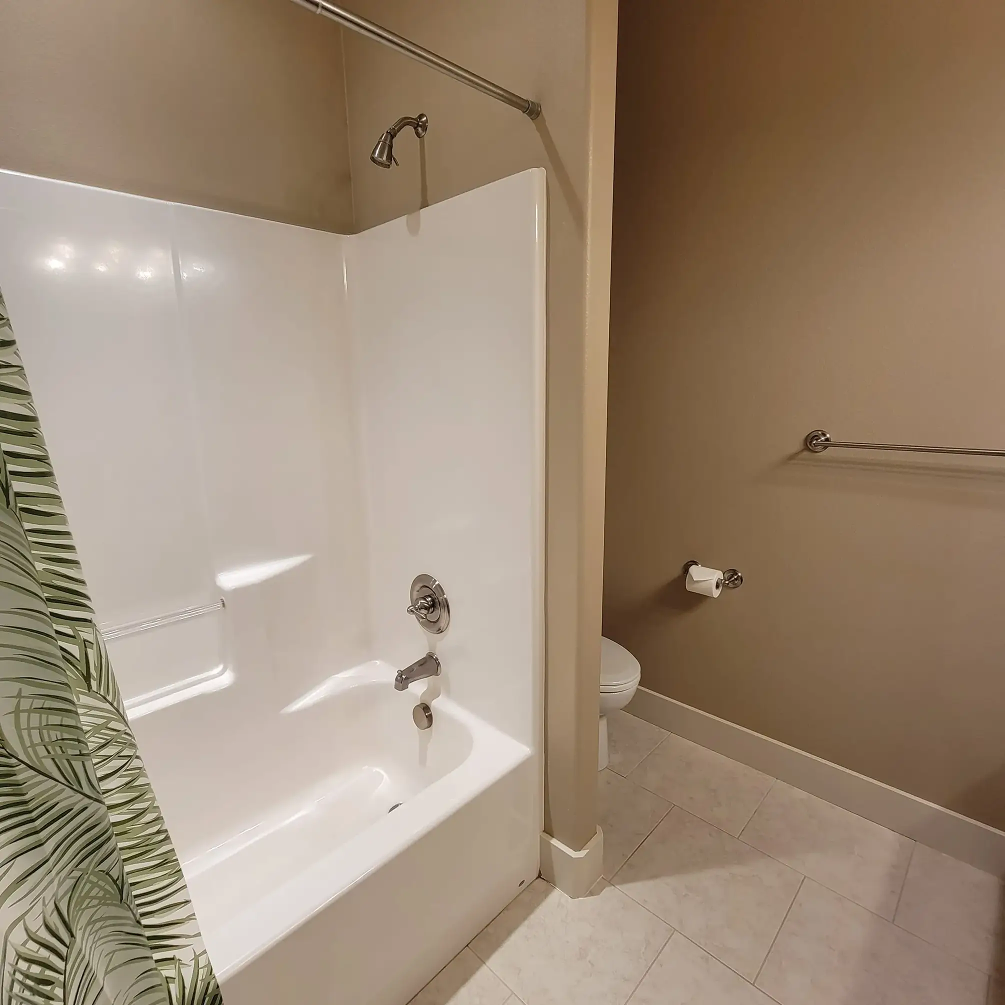 Modern bathroom with shower and toilet.