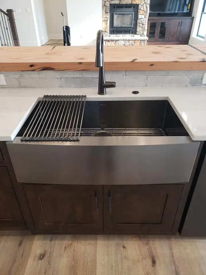 Modern kitchen sink with faucet and drying rack.