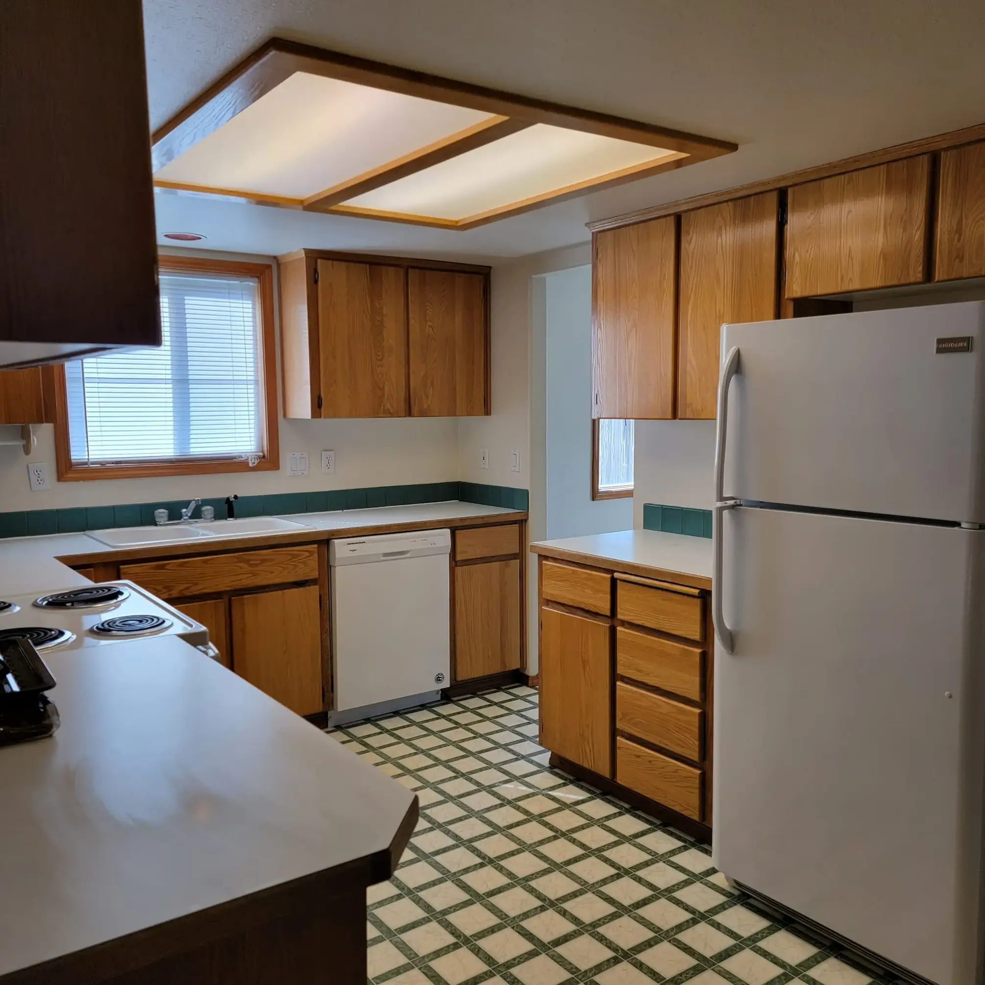 Wooden kitchen with white fridge and appliances